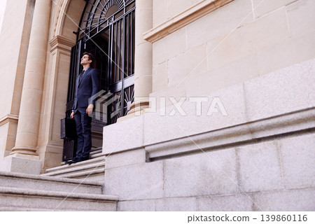 Lawyer, business and thinking with man, stairs and peaceful with professional and confidence. Person, outdoor and attorney with suitcase and office buildings with ideas and worker with legal aid 139860116