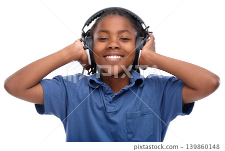 Child, music and smile with portrait and headphones with audio in a studio. Happy, fun listening and streaming radio of African male boy with casual fashion and podcast sound by a white background 139860148