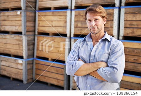 Portrait, business man or arms crossed at warehouse for shipping, distribution or storage. Face, confidence or professional winemaker at factory with crates at wine cellar in France for manufacturing 139860154