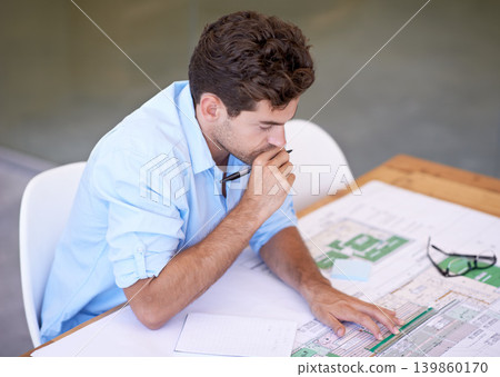 Architect, thinking or man in office with blueprint, brainstorming and reading paper for building project. Designer, engineer or creative developer at desk with floor plan for remodeling upgrade. Architect, thinking or man in office with blueprint, brainstorming and reading paper for building project. Designer, engineer or creative developer at desk with floor plan for remodeling upgrade. 139860170