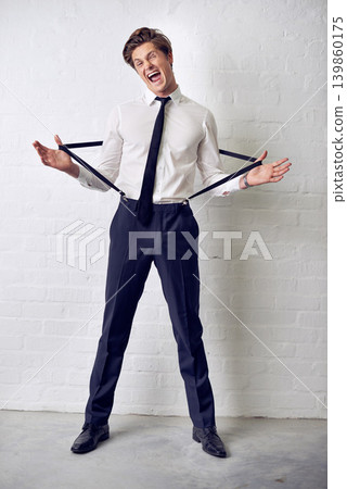 Man, funny and fashion with crazy, confidence and suit with trendy and stylish clothes. Hipster, male person and wall with event, classic and fancy suspenders with dressing formal and funny joke Man, funny and fashion with crazy, confidence and suit with trendy and stylish clothes. Hipster, male person and wall with event, classic and fancy suspenders with dressing formal and funny joke 139860175