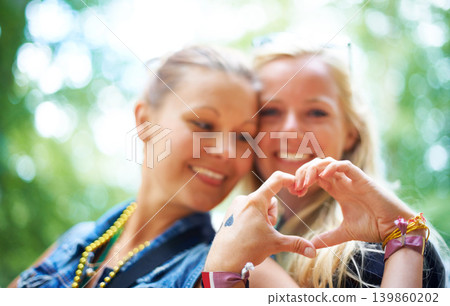 Friends, heart gesture and smile at festival to party, celebrate and summer in California for bonding, enjoy and entertainment. Event, outdoor and happiness at concert with music for enjoyment Friends, heart gesture and smile at festival to party, celebrate and summer in California for bonding, enjoy and entertainment. Event, outdoor and happiness at concert with music for enjoyment 139860202