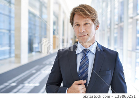 Portrait, office and business man in hallway for entrepreneurship, pride and confidence for company. Corporate manager, professional and mature person in building for career, job and opportunity Portrait, office and business man in hallway for entrepreneurship, pride and confidence for company. Corporate manager, professional and mature person in building for career, job and opportunity 139860251