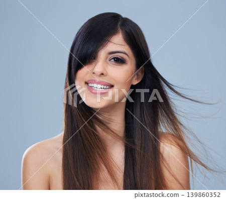 Studio, model and happy in portrait with long hair, mock up and keratin treatment with salon result. Arab woman, face and smile for conditioner for hairdresser, shine and brunette by blue background 139860352