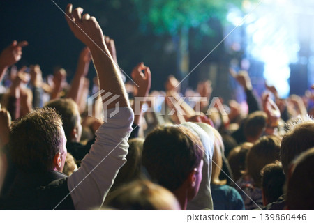 Hands, people and music festival with dancing for party at concert with stage lights, nightclub or dj. Crowd, nature and entertainment for holiday techno in summer for new years, adventure or rave Hands, people and music festival with dancing for party at concert with stage lights, nightclub or dj. Crowd, nature and entertainment for holiday techno in summer for new years, adventure or rave 139860446