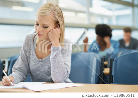 Woman, writing test or college student with notes in class, classroom or lecture for exam or education. University, smile or person in campus for knowledge or studying a course in academy or school Woman, writing test or college student with notes in class, classroom or lecture for exam or education. University, smile or person in campus for knowledge or studying a course in academy or school 139860511