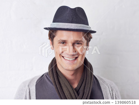 Happy, fashion and portrait of man by wall with casual, cool and trendy outfit for confidence. Smile, handsome and young male person with attractive style and hat standing by white brick background. Happy, fashion and portrait of man by wall with casual, cool and trendy outfit for confidence. Smile, handsome and young male person with attractive style and hat standing by white brick background. 139860518