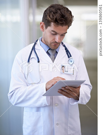 Research, tablet and doctor in hospital for medical information on the internet for diagnosis. Reading, professional and male healthcare worker with telehealth on digital technology in clinic. Research, tablet and doctor in hospital for medical information on the internet for diagnosis. Reading, professional and male healthcare worker with telehealth on digital technology in clinic. 139860561