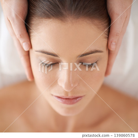 Hands, top view and facial massage of woman at spa to relax, peace and closeup at luxury resort with masseuse. Above, therapy and person at salon for face treatment, skincare and beauty for wellness Hands, top view and facial massage of woman at spa to relax, peace and closeup at luxury resort with masseuse. Above, therapy and person at salon for face treatment, skincare and beauty for wellness 139860578
