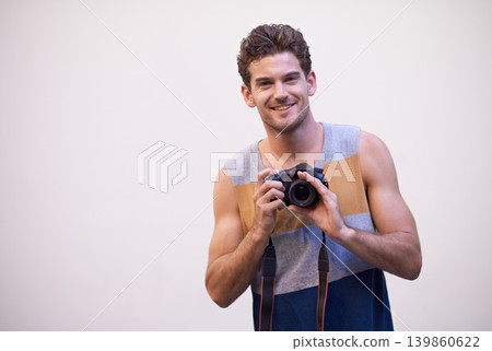 Man, camera and photographer in studio portrait, digital lens and tech for image or picture. Male person, hobby and equipment for photo on white background, mockup space and capture for memories Man, camera and photographer in studio portrait, digital lens and tech for image or picture. Male person, hobby and equipment for photo on white background, mockup space and capture for memories 139860622