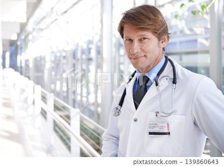 Smile, pride and portrait of doctor in hospital with positive, good and confident attitude. Happy, medical career and face of professional mature male healthcare worker in medicare clinic corridor. Smile, pride and portrait of doctor in hospital with positive, good and confident attitude. Happy, medical career and face of professional mature male healthcare worker in medicare clinic corridor. 139860643