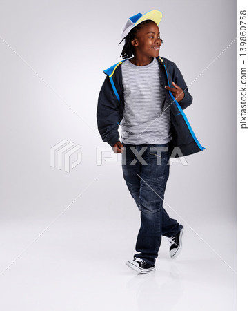 African boy, talent and dancing for fashion in studio for hiphop in backdrop of white background. Child, funky and happiness with smile of youth for kids clothes and mockup space with stylish person African boy, talent and dancing for fashion in studio for hiphop in backdrop of white background. Child, funky and happiness with smile of youth for kids clothes and mockup space with stylish person 139860758