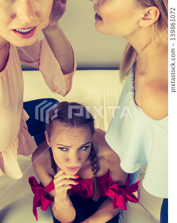 Woman being gossiped by two 139861072