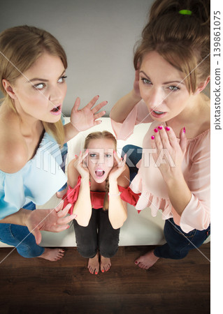 Woman being gossiped by two 139861075