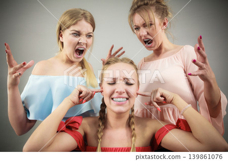 Woman being bullied by two females 139861076