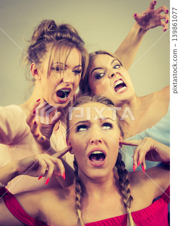 Woman being bullied by two females 139861077