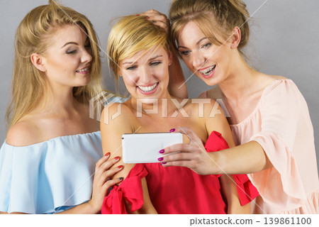 Fashionable women taking selfie 139861100