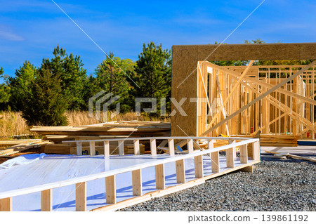 Workers are using wood frames materials to build beams structure in forested area under construction site Workers are using wood frames materials to build beams structure in forested area under construction site 139861192