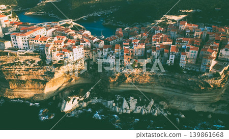 An ancient city with dense buildings on a cliff above the sea surf An ancient city with dense buildings on a cliff above the sea surf 139861668