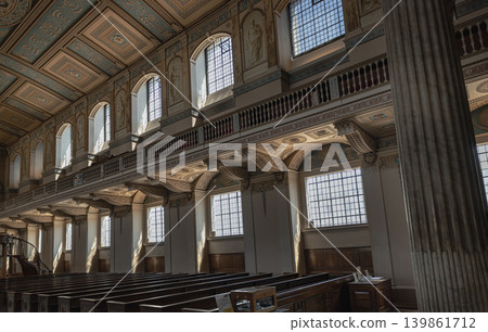 An angled view highlights the majestic upper gallery of the Chapel of St Peter & St Paul. Sunlight streams through multi-paned arched windows. An angled view highlights the majestic upper gallery of the Chapel of St Peter & St Paul. Sunlight streams through multi-paned arched windows. 139861712