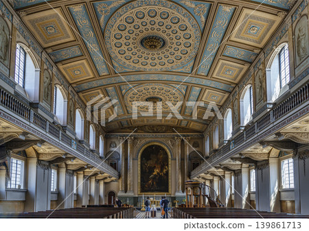 The sunlit nave of the Chapel of St Peter & St Paul showcases neoclassical mastery, flanked by tiered galleries and symmetrical windows. Overhead, a barrel-vaulted ceiling of intricate pale blue and The sunlit nave of the Chapel of St Peter & St Paul showcases neoclassical mastery, flanked by tiered galleries and symmetrical windows. Overhead, a barrel-vaulted ceiling of intricate pale blue and 139861713