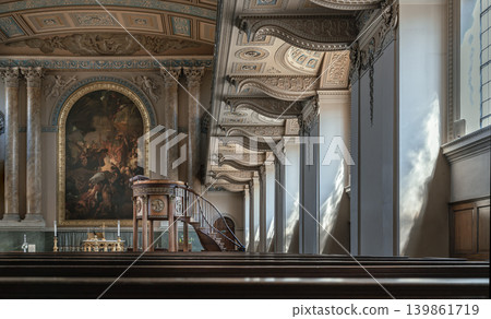 Viewed across dark wooden pews, the breathtaking altar of the Chapel of St Peter & St Paul unfolds in classical majesty. A grand altarpiece painting is framed by soaring Corinthian columns and an Viewed across dark wooden pews, the breathtaking altar of the Chapel of St Peter & St Paul unfolds in classical majesty. A grand altarpiece painting is framed by soaring Corinthian columns and an 139861719