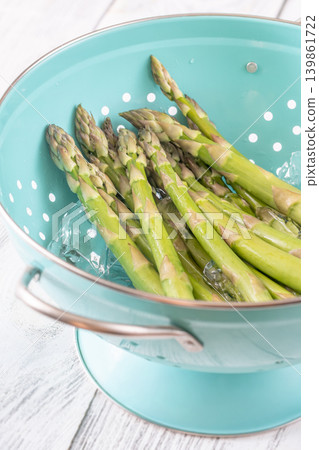 Fresh Green Asparagus Chilling In Ice Water During Blanching Preparation Process Fresh Green Asparagus Chilling In Ice Water During Blanching Preparation Process 139861722
