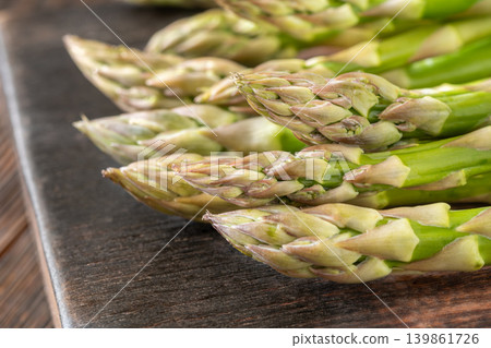 Fresh Green Asparagus Buds Macro Close Up On Dark Rustic Wooden Board 139861726