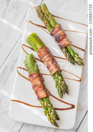 Gourmet Bacon Wrapped Asparagus With Balsamic Glaze On White Ceramic Plate Gourmet Bacon Wrapped Asparagus With Balsamic Glaze On White Ceramic Plate 139861729