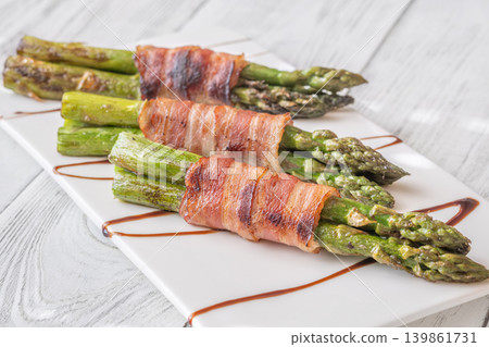 Gourmet Bacon Wrapped Asparagus With Balsamic Glaze On White Ceramic Plate Gourmet Bacon Wrapped Asparagus With Balsamic Glaze On White Ceramic Plate 139861731