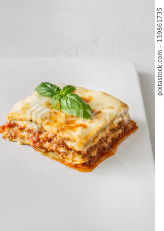 Classic Lasagna Bolognese Slice With Golden Mozzarella And Fresh Basil Garnish Classic Lasagna Bolognese Slice With Golden Mozzarella And Fresh Basil Garnish 139861735