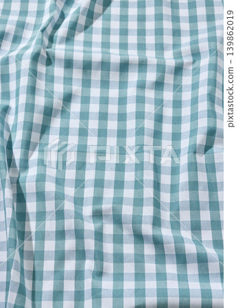 Wrinkled Blue and White Checkered Linen Tablecloth Texture Background. Top View Wrinkled Blue and White Checkered Linen Tablecloth Texture Background. Top View 139862019