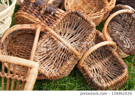 Rustic handwoven wicker trays arranged at outdoor craft marketplace display Rustic handwoven wicker trays arranged at outdoor craft marketplace display 139862039