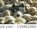 A felt wolf mingled with a flock of sheep. Odd one out. Wolf among sheep. 139862060