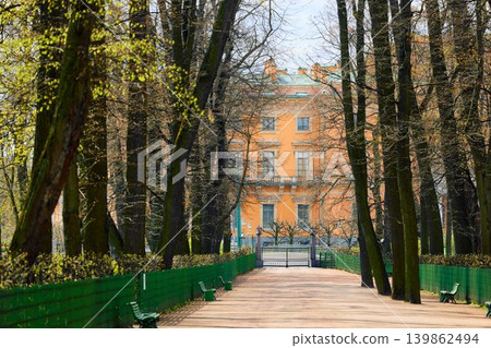 Russia, St.Petersburg, people stroll through the summer garden on a sunny May morning, alleys of trees and statues, the Fontanka River embankment with a view of the engineering castle Russia, St.Petersburg, people stroll through the summer garden on a sunny May morning, alleys of trees and statues, the Fontanka River embankment with a view of the engineering castle 139862494