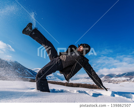 Man slipped and falling in deep snow on winter mountains background Man slipped and falling in deep snow on winter mountains background 139862507