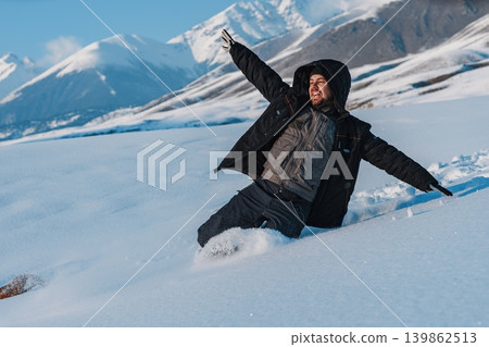 Young man tourist sliding down from mountain at winter season Young man tourist sliding down from mountain at winter season 139862513