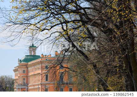 Engineering castle across the Moika River with a beautiful embankment on a sunny May morning, Russia, St.Petersburg Engineering castle across the Moika River with a beautiful embankment on a sunny May morning, Russia, St.Petersburg 139862545