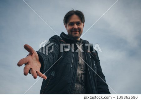 Man extends his hand to the camera, focus on hand, help concept Man extends his hand to the camera, focus on hand, help concept 139862680