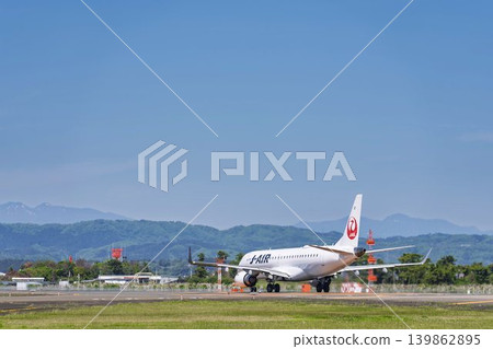 Sendai Airport under a blue sky; a plane taking off; Natori City, Miyagi Prefecture Sendai Airport under a blue sky; a plane taking off; Natori City, Miyagi Prefecture 139862895