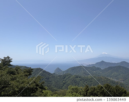 Mount Fuji in early summer, seen across the mountains of Izu and Suruga Bay. Mount Fuji in early summer, seen across the mountains of Izu and Suruga Bay. 139863449