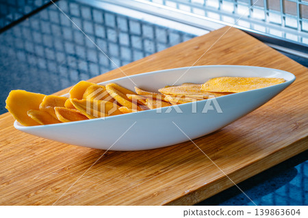 Kitchen table with dried mango in bowl Kitchen table with dried mango in bowl 139863604