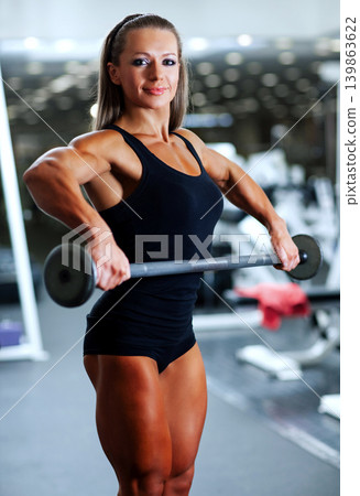 Young sports woman with barbell in gym Young sports woman with barbell in gym 139863622