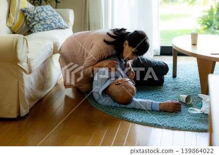 A senior man who has collapsed and a senior woman providing first aid. A senior man who has collapsed and a senior woman providing first aid. 139864022