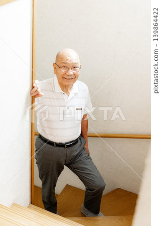Senior man climbing the stairs Senior man climbing the stairs 139864422