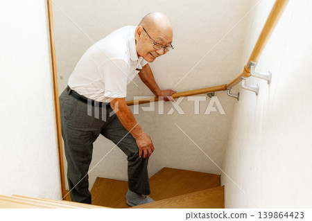 Senior man climbing the stairs Senior man climbing the stairs 139864423