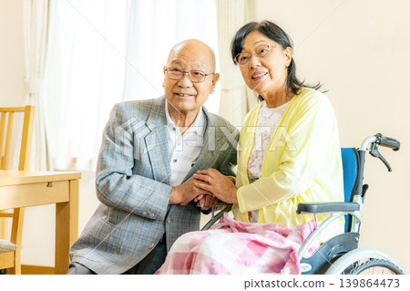 Senior couple sitting in wheelchairs Senior couple sitting in wheelchairs 139864473