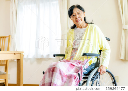 Senior woman sitting in a wheelchair Senior woman sitting in a wheelchair 139864477
