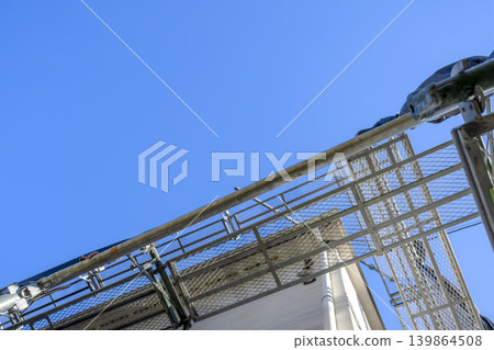 Scaffolding immediately after the start of roof renovation work, with ample space against the blue sky. 139864508