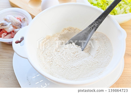 Measure the flour and other ingredients in a bowl. 139864723